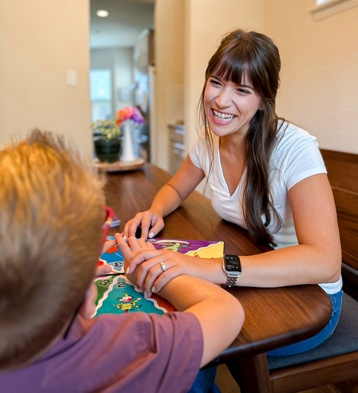 Sarah playing a board game with a child